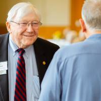 President Emeritus Don Lubbers talking with a guest at the Retiree Reception.